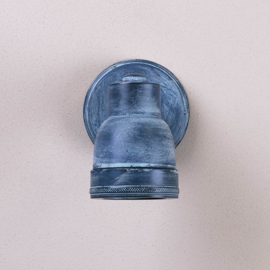 Blue wall-mounted light fixture on a beige wall
