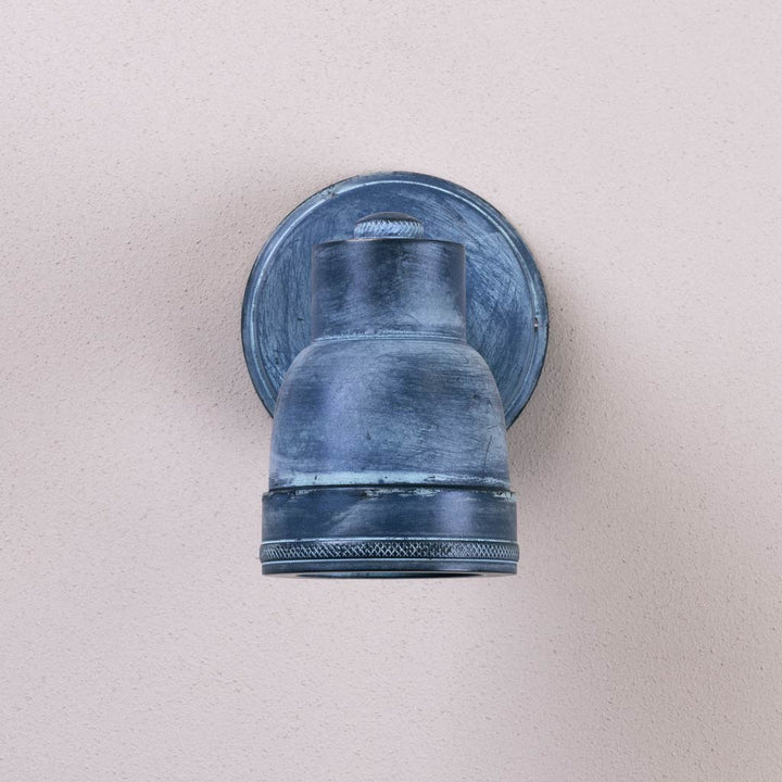 Blue wall-mounted light fixture on a beige wall
