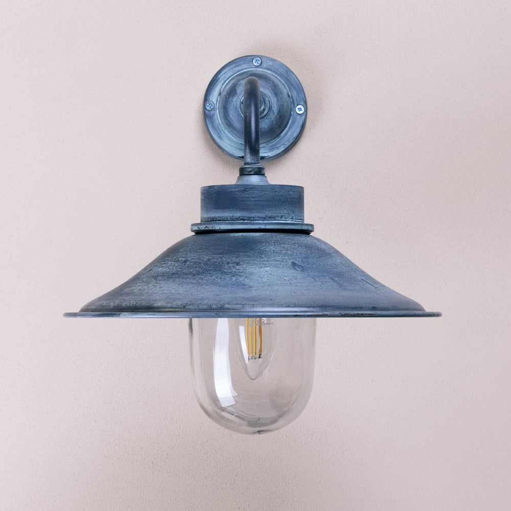 Vintage-style wall-mounted light fixture on a plain background