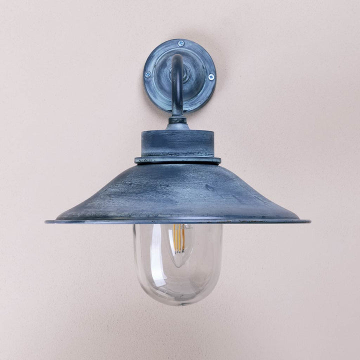 Vintage-style wall-mounted light fixture on a plain background