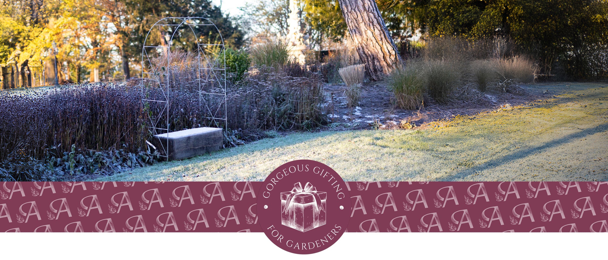 Garden scene with a decorative border featuring monograms and a gift box design.