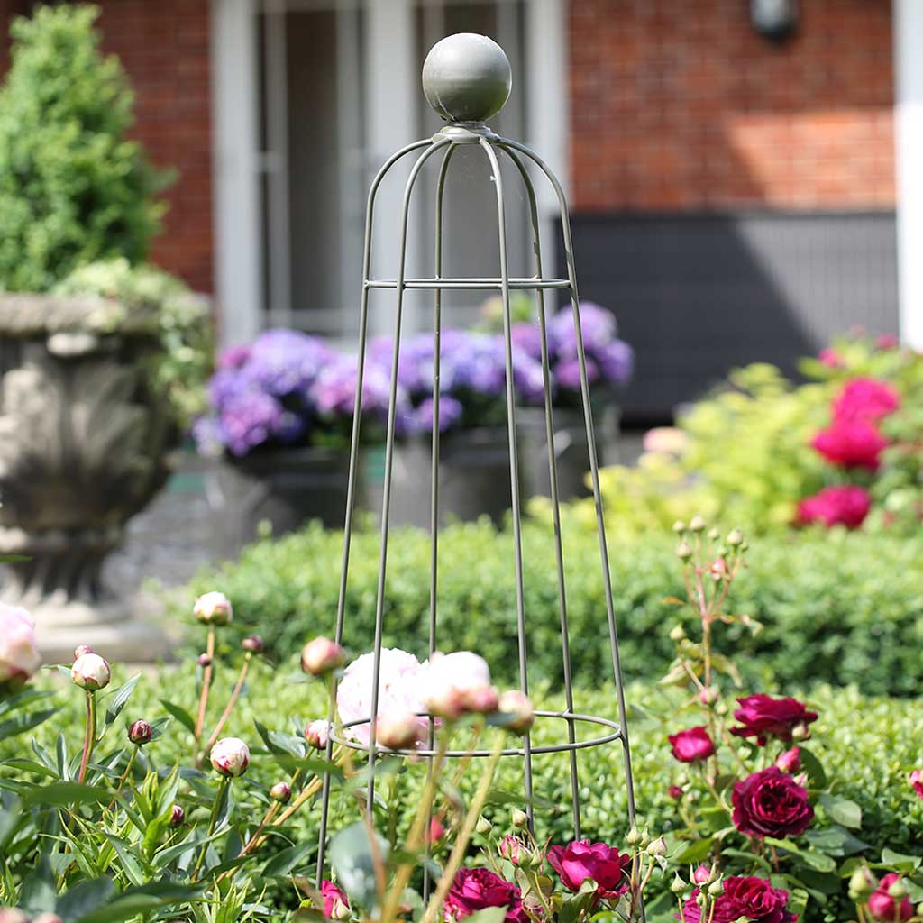 an elegant obelisks in a rose garden