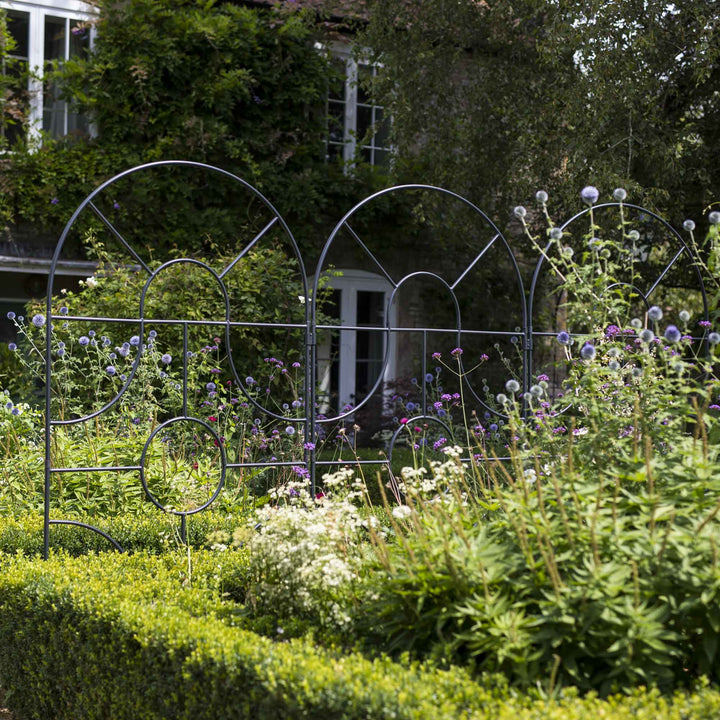 Agriframes georgian round top screens in front a cottage