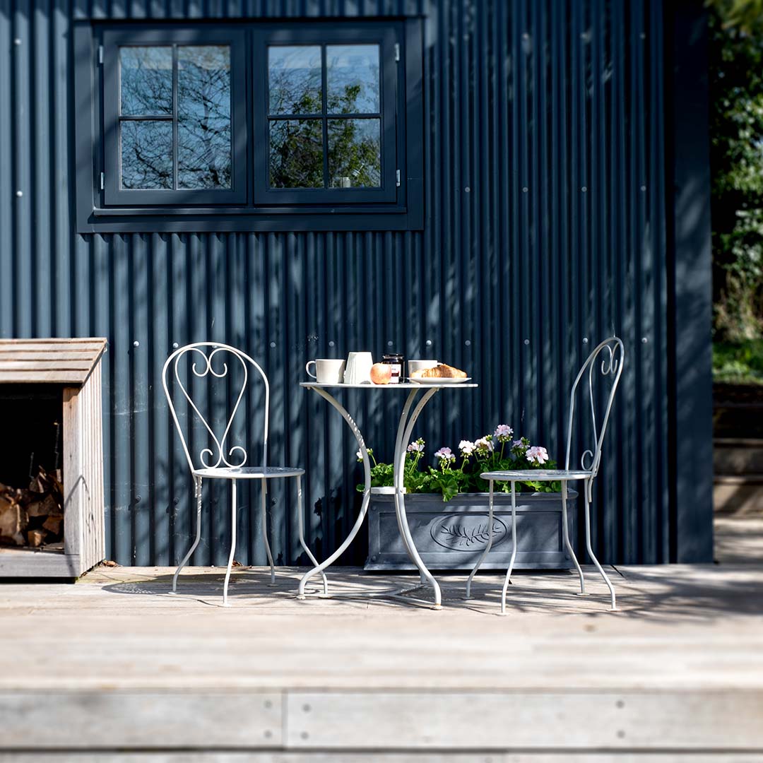 Provence Vintage Bistro Set with a dark grey background and a zinc planter behind it 