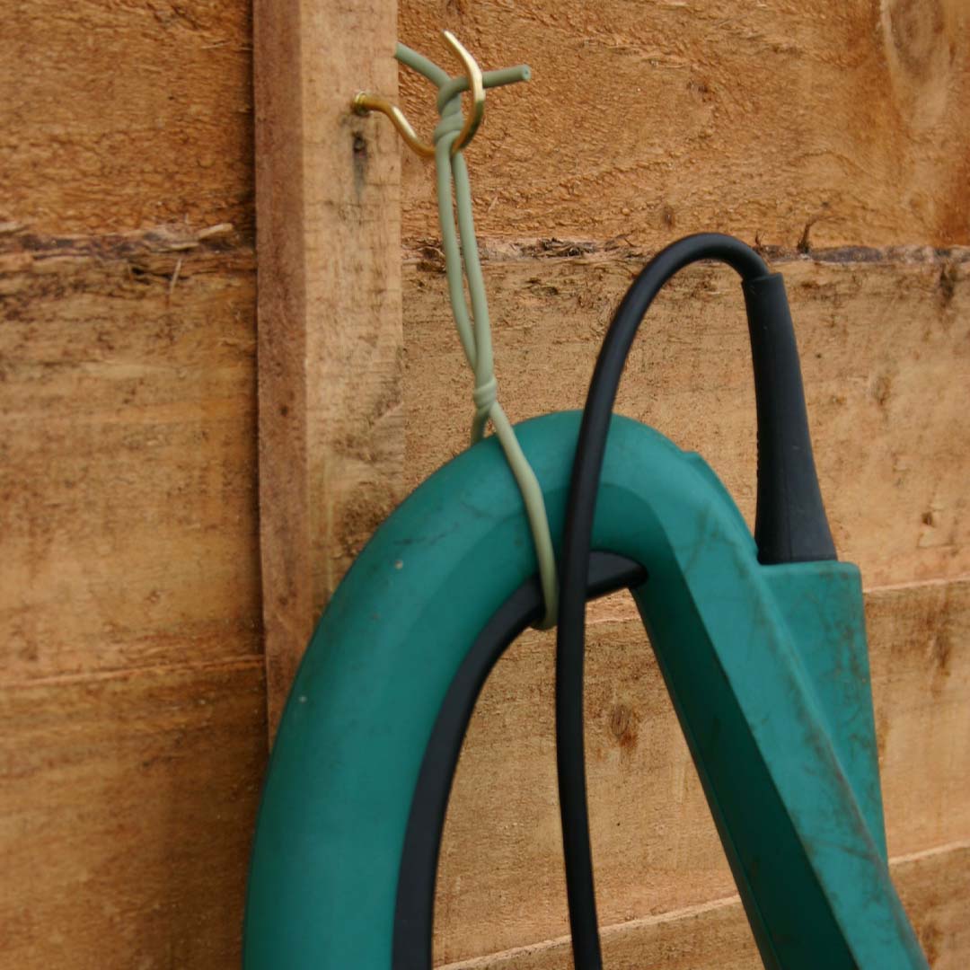 soft tie being used to hang a garden tool
