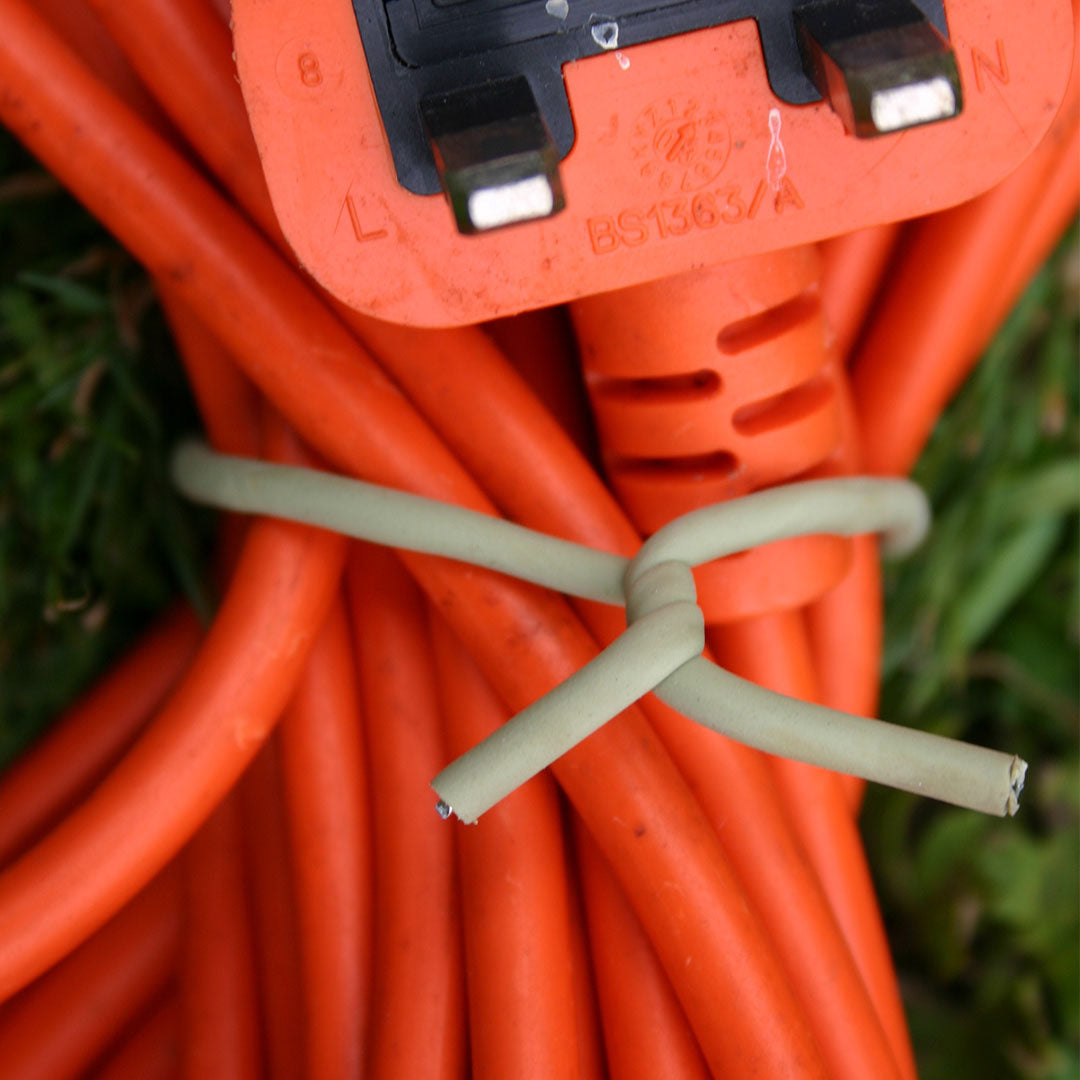 soft tie twisted around a garden tool cable