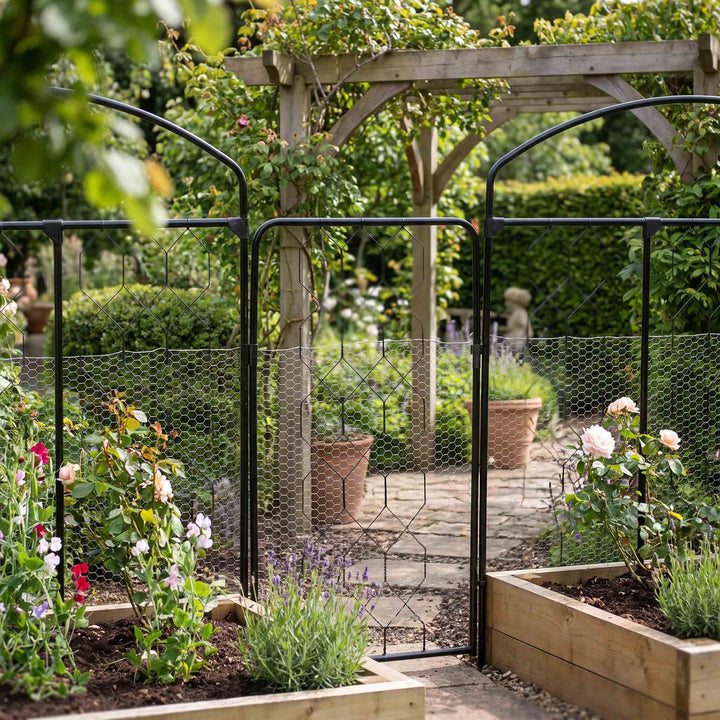 Agriframes small flat fencing screen in between monet fencing screens with raised beds in the foreground