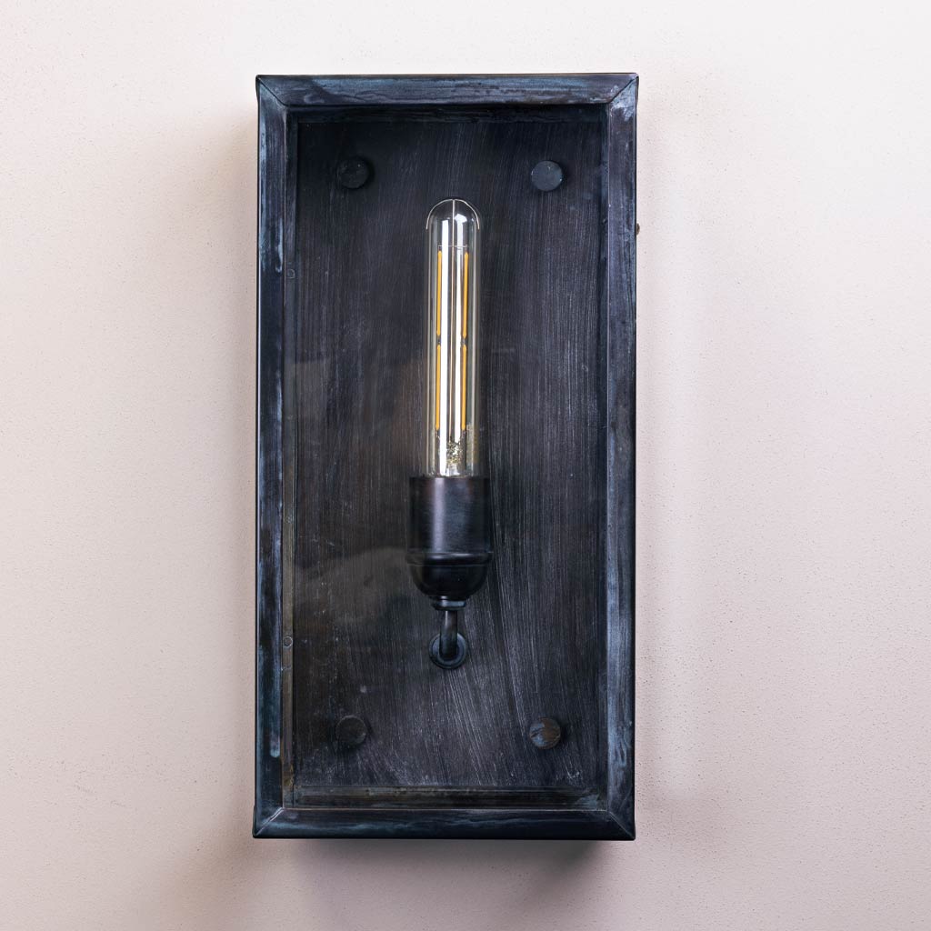 Wall-mounted light fixture with a dark wooden frame on a beige background