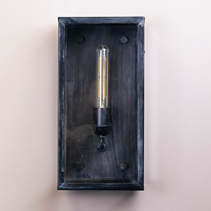 Wall-mounted light fixture with a dark wooden frame on a beige background