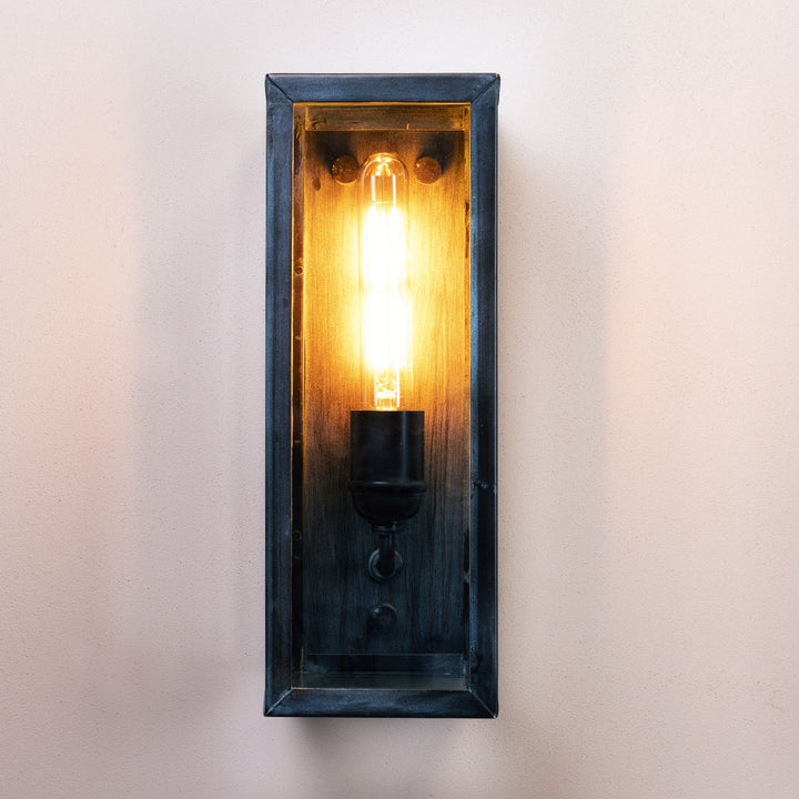 Wall-mounted light fixture with a wooden frame on a white background