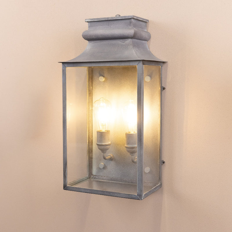 Angled image of the Agriframes Marlborough Coach Lantern with its bulbs illuminated. 