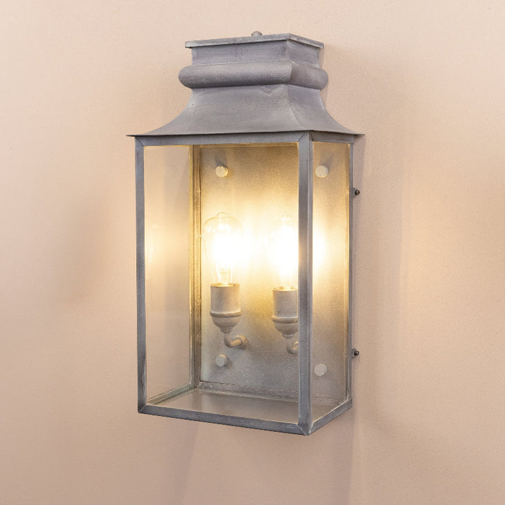 Angled image of the Agriframes Marlborough Coach Lantern with its bulbs illuminated. 