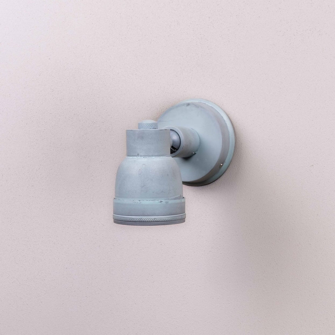 Angled shot of the Atworth Outdoor Wall Lamp with its bulb switched off mounted on an off white wall 