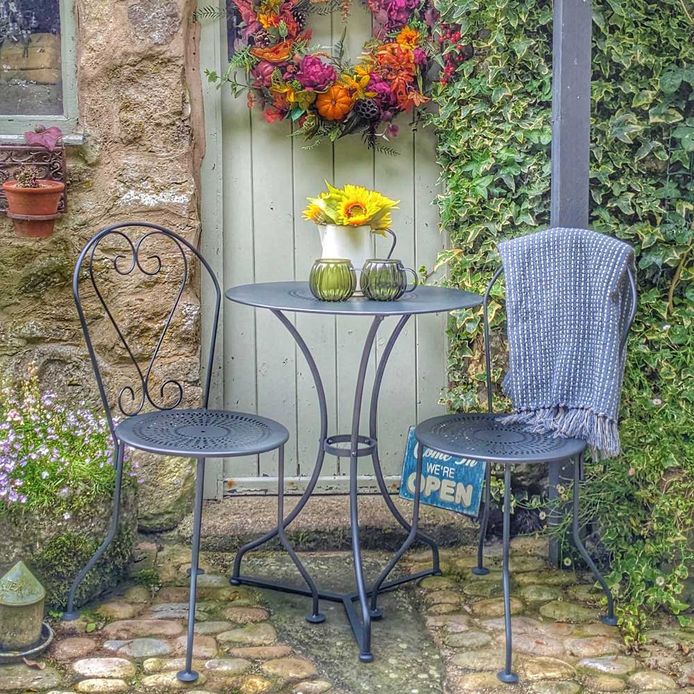 bistro chairs outside a cottage