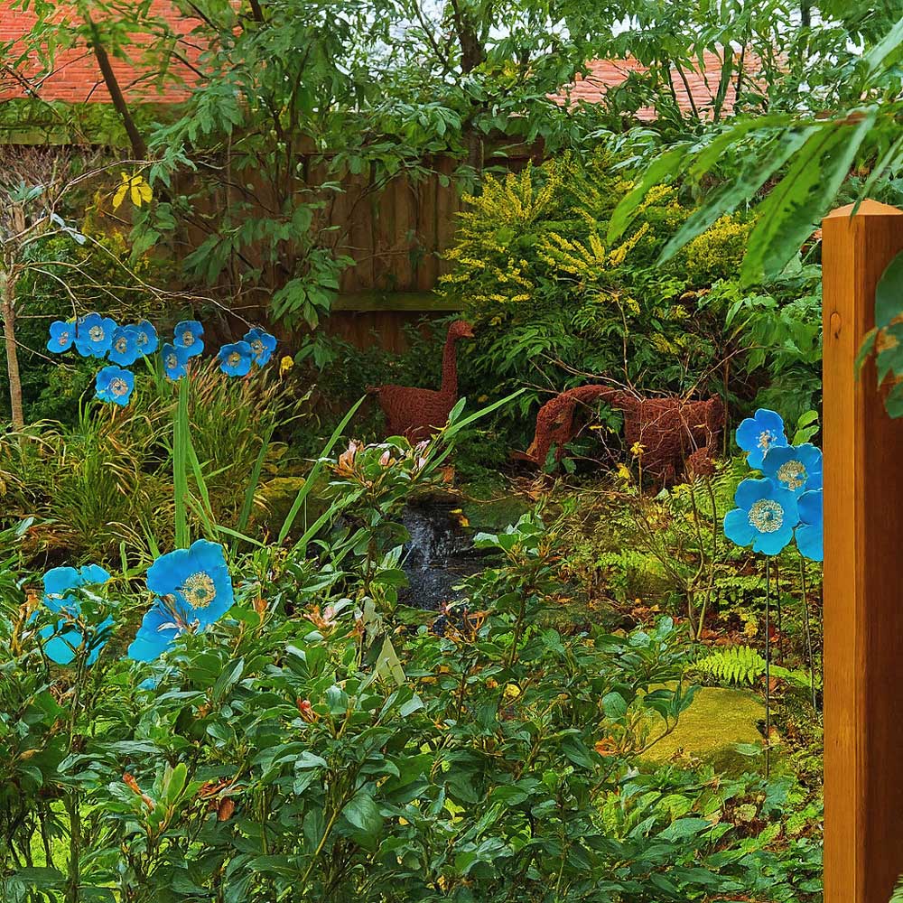 Garden scene with blue flowers, a small pond, and dinosaur statues.