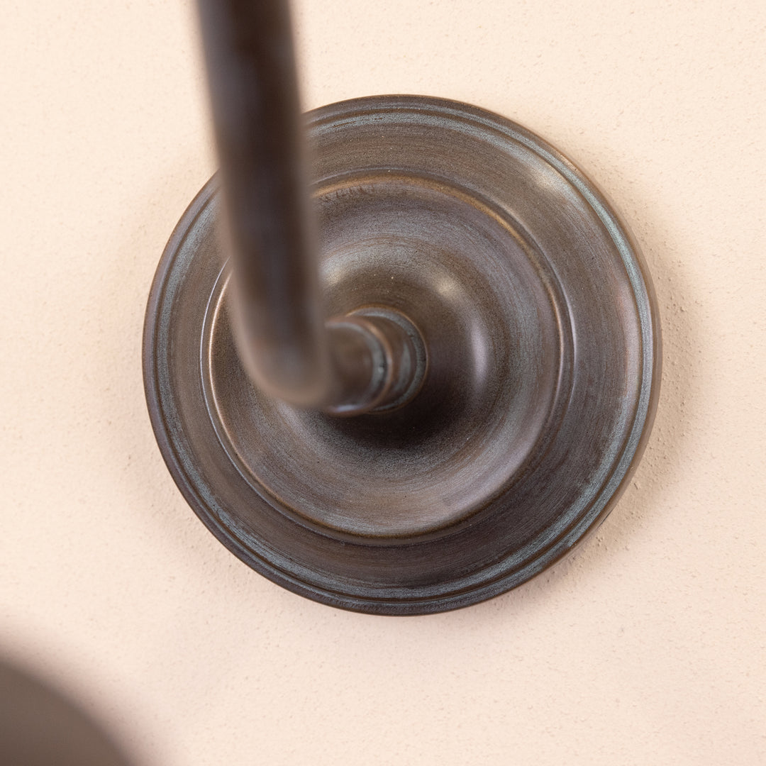 Closeup image of the base and stem of the Agriframes Bucklebury Outdoor Wall Lamp in a Copper Patina finish. 