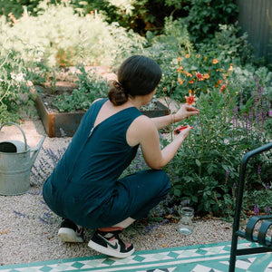woman taking cuttings in garden
