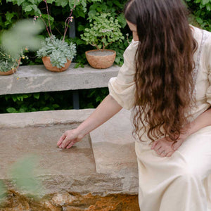 woman sat on stone bench
