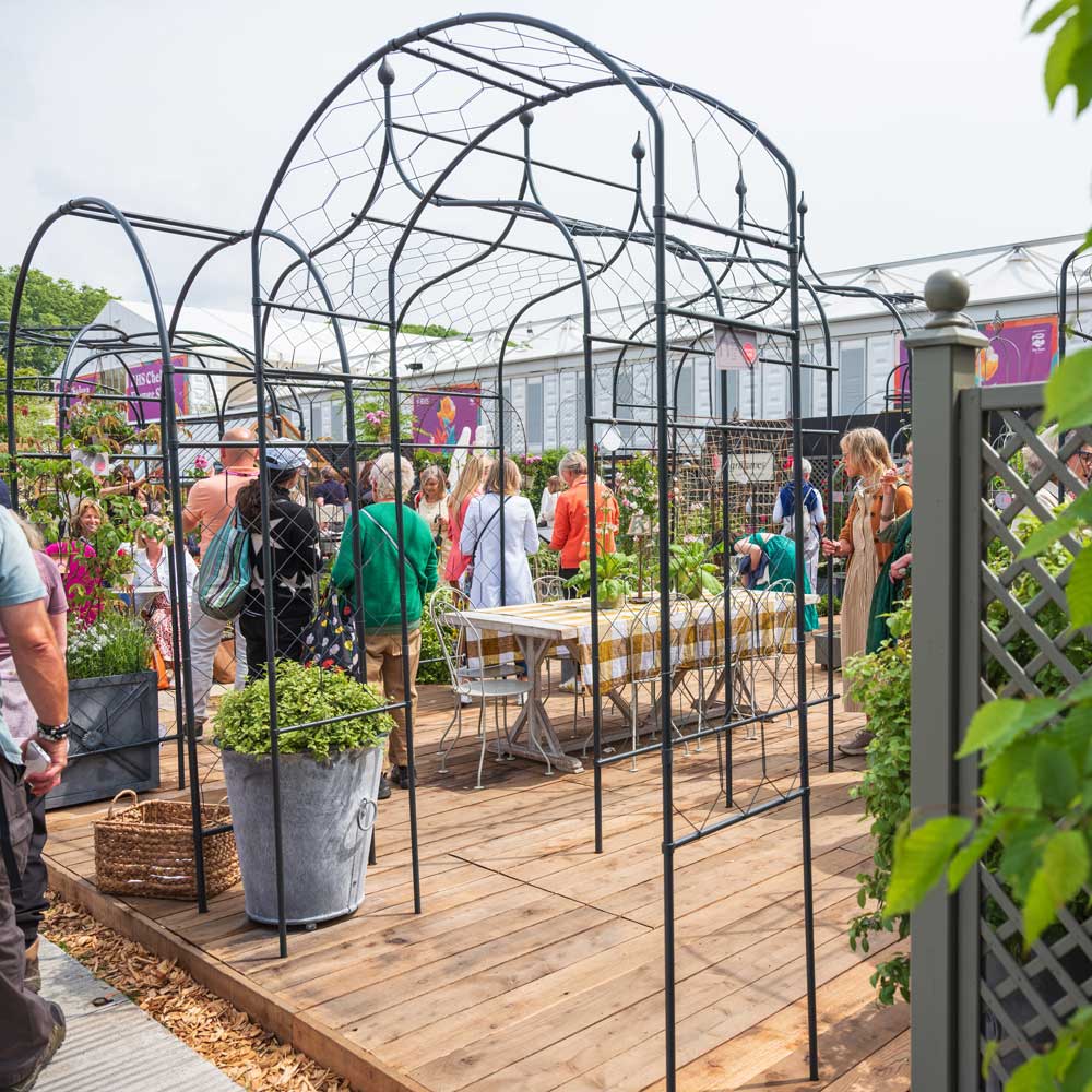 Monet Arch at RHS Chelsea Flower Show with people and Arches in the background 