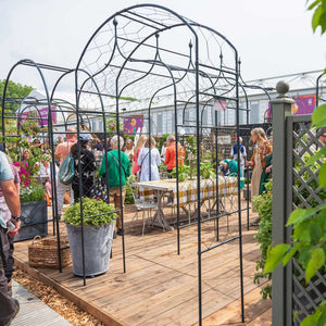 Monet Arch at RHS Chelsea Flower Show with people and Arches in the background 