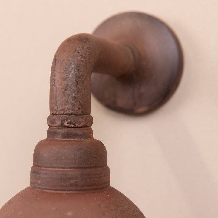 Closeup image of the Agriframes Trowbridge Outdoor Wall Lamp in a Rust finish.