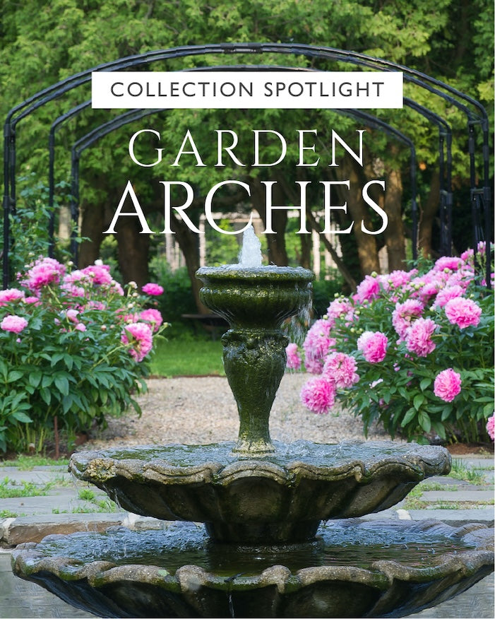 Agriframes monet arch on a garden path with pink roses growing at the base and a stone water fountain in the foreground, overlaid with the text "collection spotlight: garden arches"