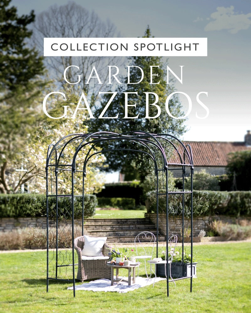 Agriframes round gazebo on a lawn with chairs and a table underneath, overlaid with the text "collection spotlight: garden gazebos"