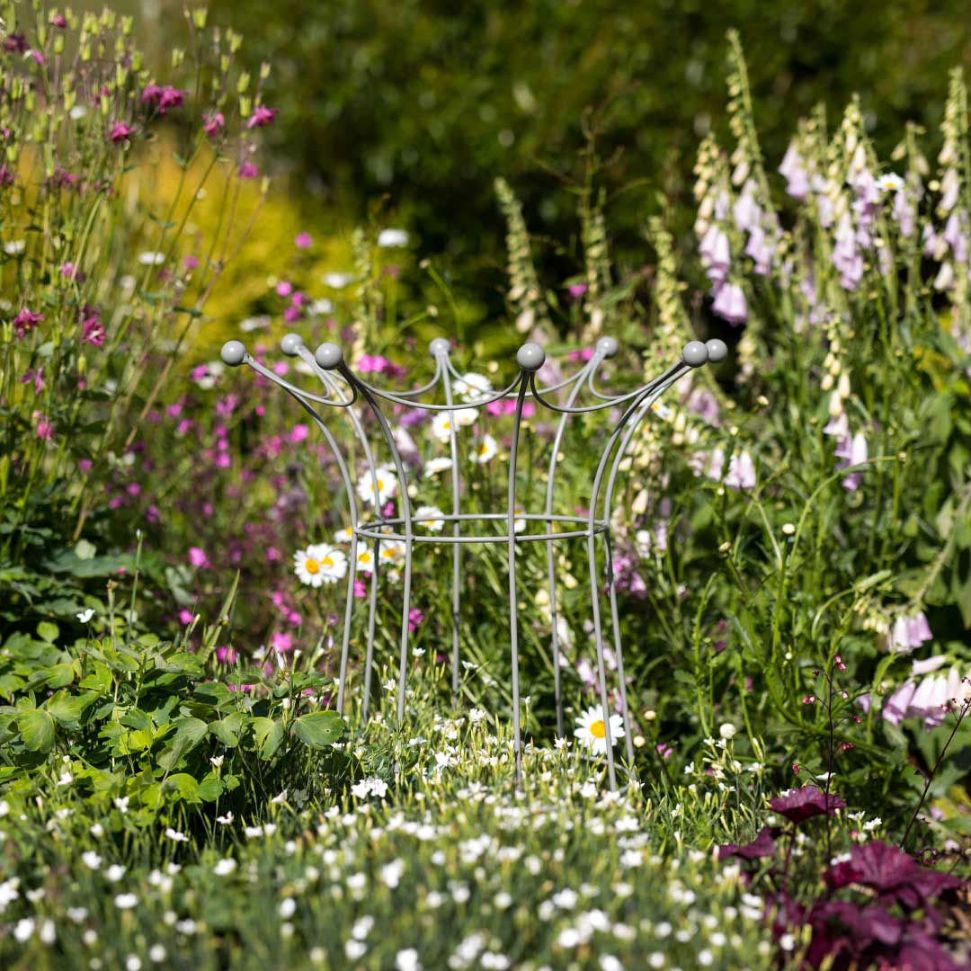 Agriframes elegance coronet obelisk in a sage green finish in a flowerbed