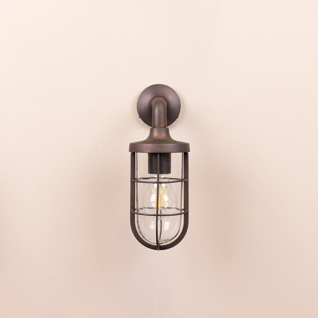 Front on image of the Agriframes Exmouth Outdoor Wall Lamp in a Bronze finish with its bulb switched off, mounted on a neutral background. 