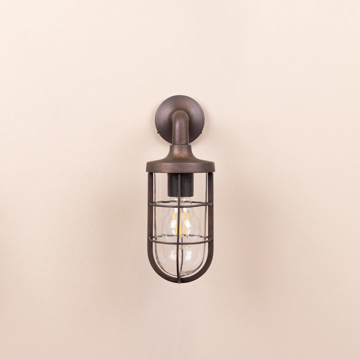 Front on image of the Agriframes Exmouth Outdoor Wall Lamp in a Bronze finish with its bulb switched off, mounted on a neutral background. 