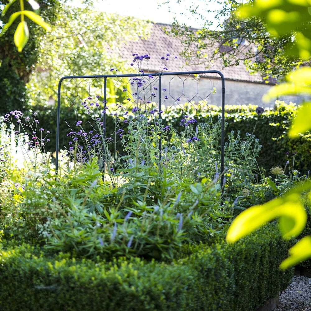 Agriframes standard flat fencing screen in a hedged flowerbed