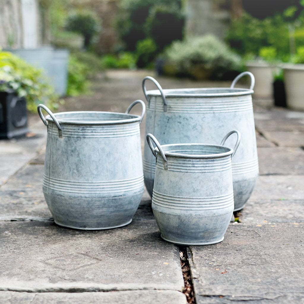 Galvanised Zinc Planters in a set of three on a stone patio