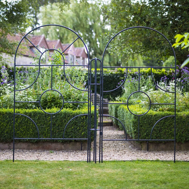 Two Agriframes georgian top round screens on the edge of a lawn in a large garden scene