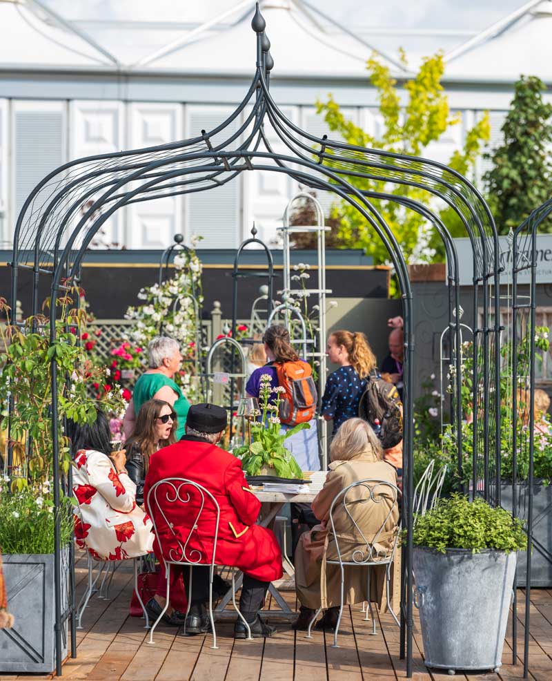 Gothic Pergola at RHS Chelsea Flower Show with Arches and people in the background