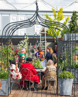Gothic Pergola at RHS Chelsea Flower Show with Arches and people in the background