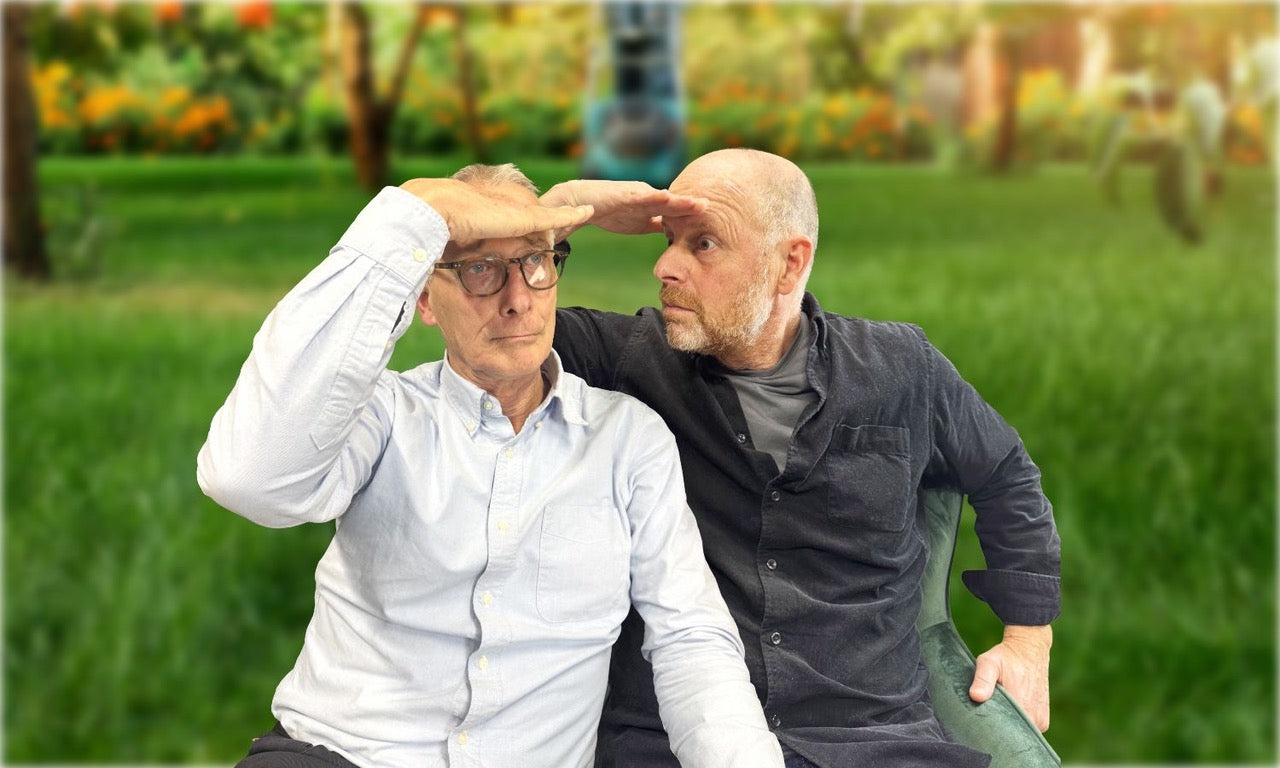 Two men sat on a bench with hands over their brows.