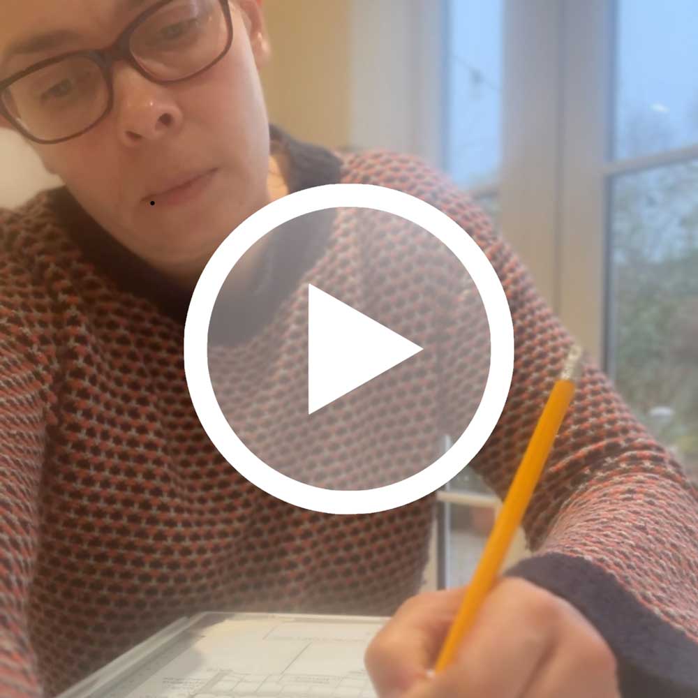 video screenshot of woman journalling