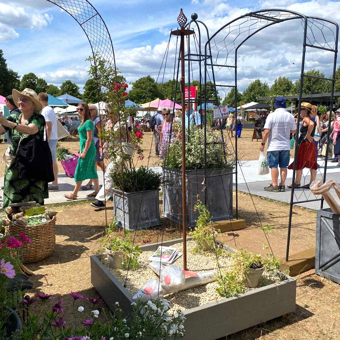 Elegance Maypole at Harrogate Flower Show with people in the background, in rustic