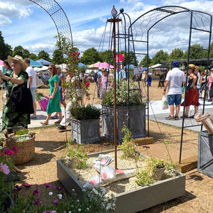 Elegance Maypole at Harrogate Flower Show with people in the background, in rustic