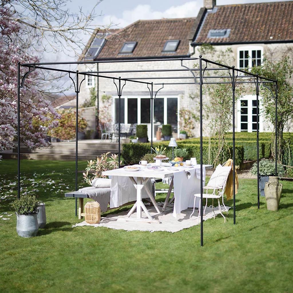 Provence Pergola in a stunning setting with table and chairs underneath 