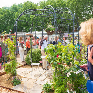 Round Gazebo at the RHS Chelsea Flower Show with a Bath Stone Bistro set placed in the middle 