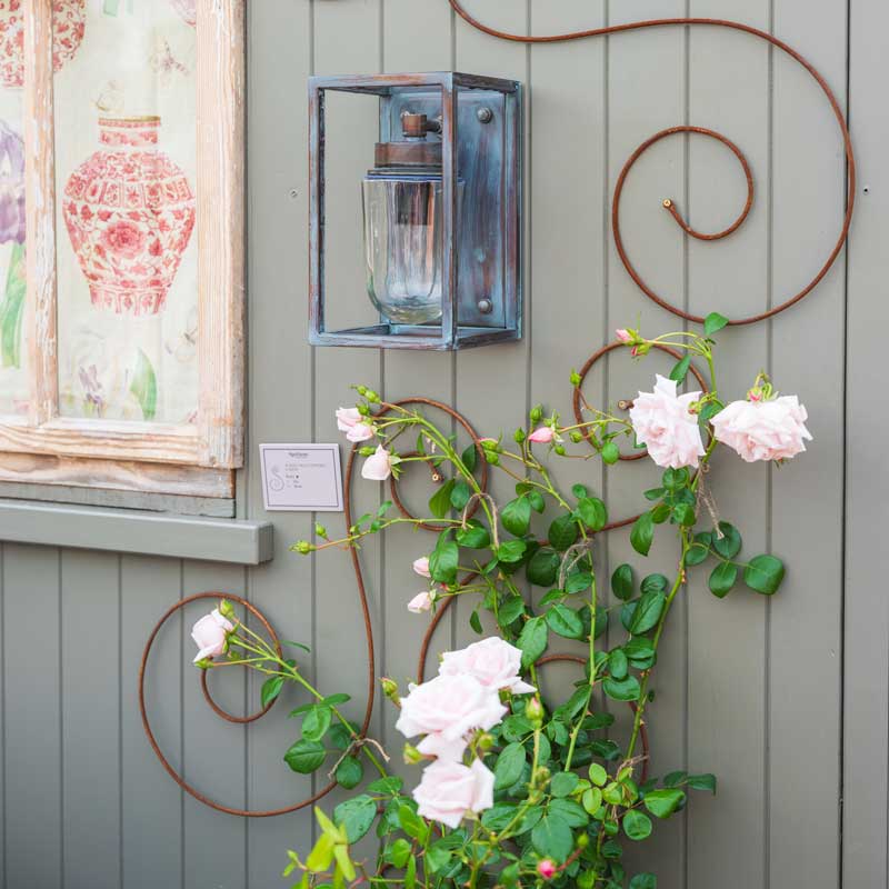 Scroll Trellis at Chelsea Flower Show with flowers growing up