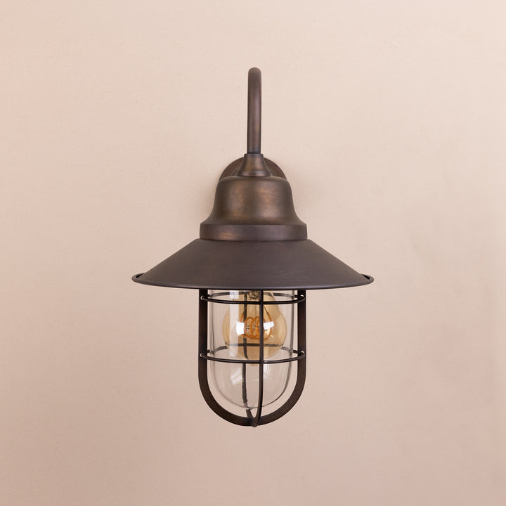 Front on image of the Agriframes Sidmouth Outdoor Wall Lamp in a Bronze finish with its bulb switched off, mounted on a neutral background. 