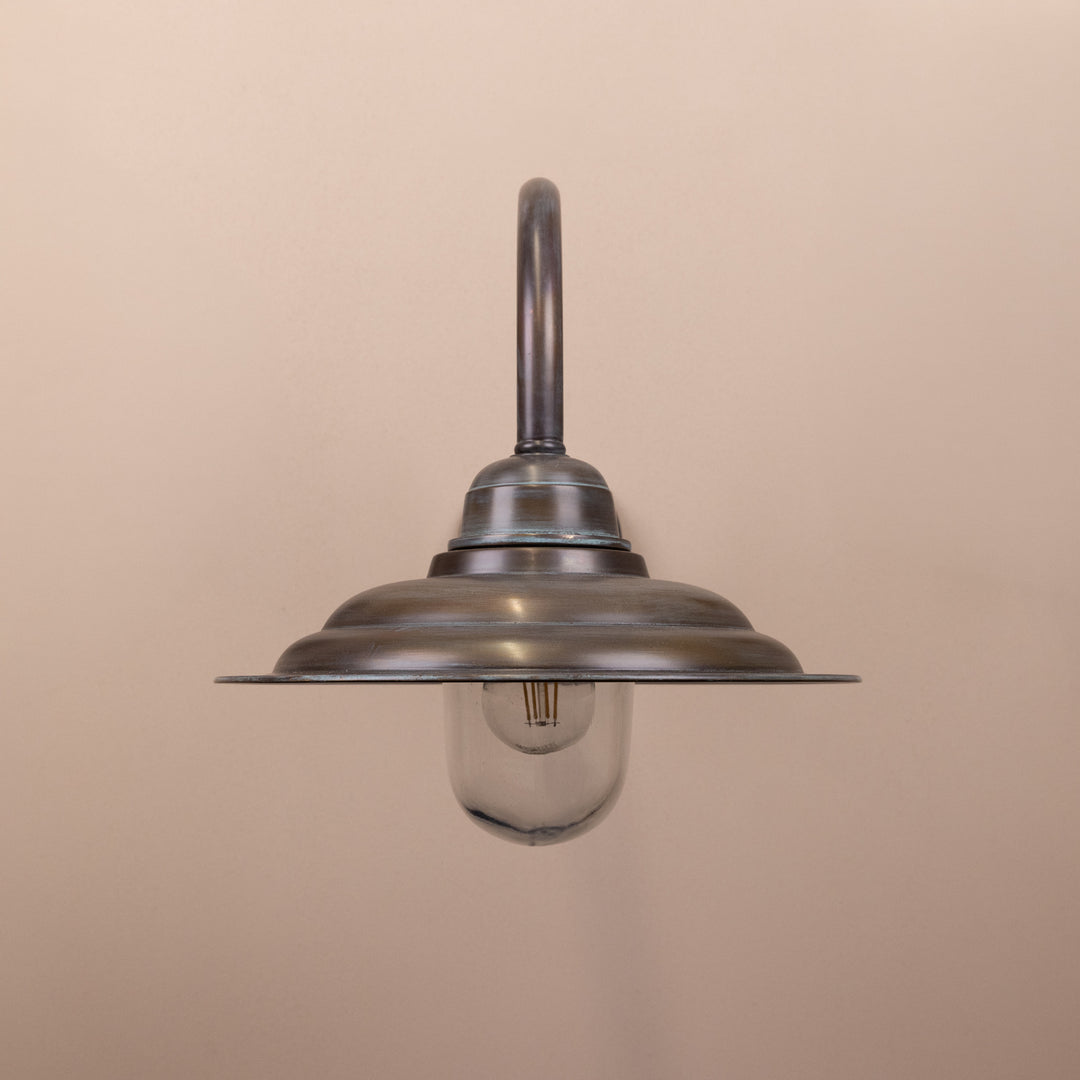 Front on image of the Agriframes Tetbury Outdoor Wall Lamp in a Copper Patina finish with its bulb switched off, mounted on a neutral background. 