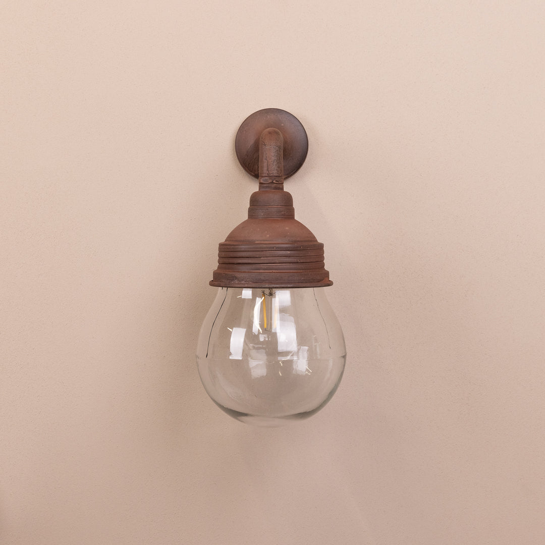 Front on image of the Agriframes Trowbridge Outdoor Wall Lamp in a Rust  finish with its bulb switched off, mounted on a neutral background. 