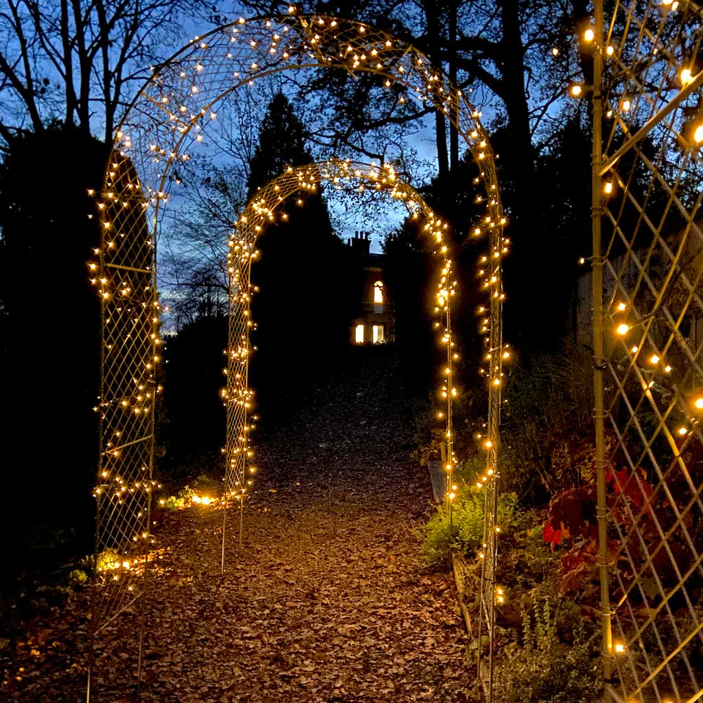 fairy lights on metal garden arch