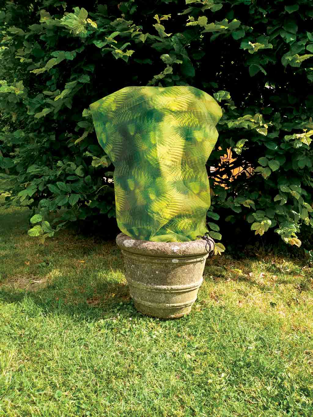Green Ferne / Camouflage Fleece Jacket size small in use on potted plant in garden 
