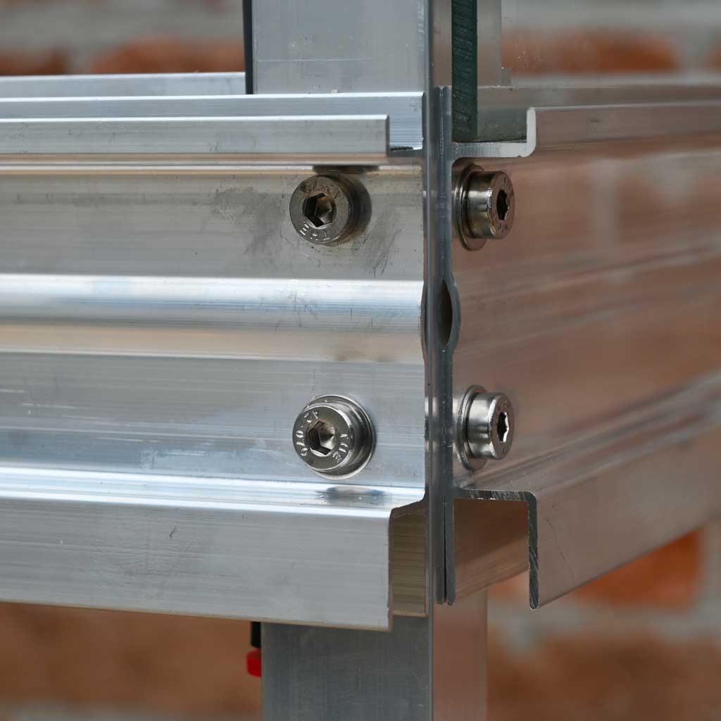 Close-up of a metal frame with screws on a blurred background